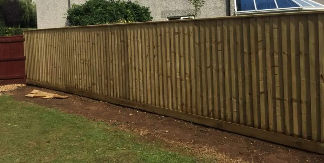 Close board feather edge fence installation with new posts and gravel boards